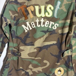 Upcycled Army Camo with Leather Trust Matters design on back